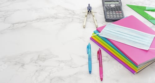 Preview: Closeup shot of notebooks, protective mask, pens, calculator, ruler, compass on marble background