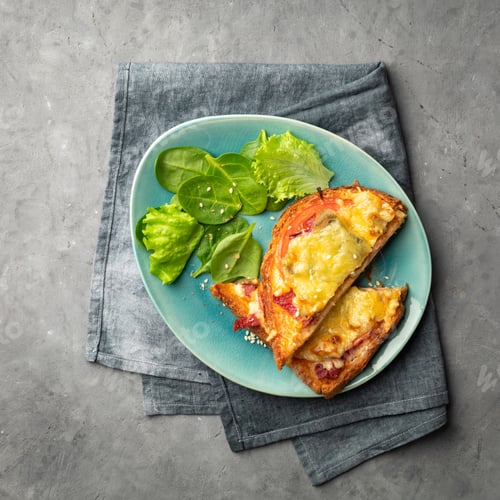Preview: Sandwiches cooked in the oven with tomato, cheese and herbs on a plate.
