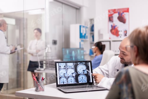Preview: Radiologist pointing at brain ct scan