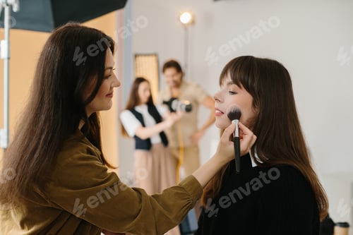 Preview: Backstage from a studio photo session, the team works on the set.