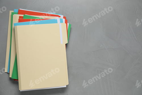 Preview: Many documents in folders on grey table, top view. Space for text