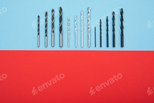 Preview: Set of drills are spread out in a row on red-blue background