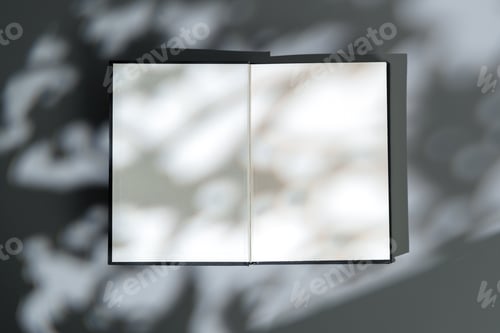 Preview: Blank open notepad on gray background studio shot