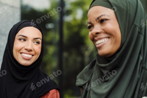 Preview: Multiracial muslim women laughing while walking together