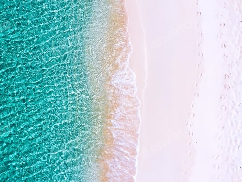 Preview: Drone shot of turquoise colored ocean waves and white sandy beach