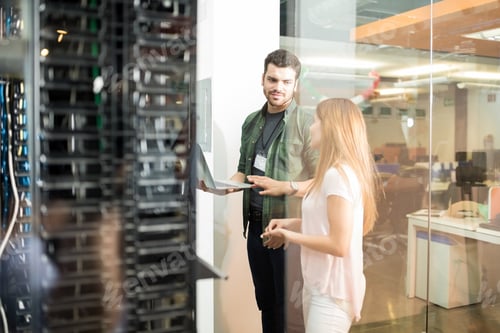Preview: Colleagues discussing in office server room