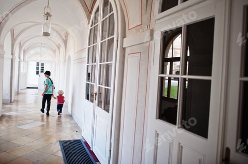 Preview: Brother with little sister walking at Veveri castle, Czech Republic.