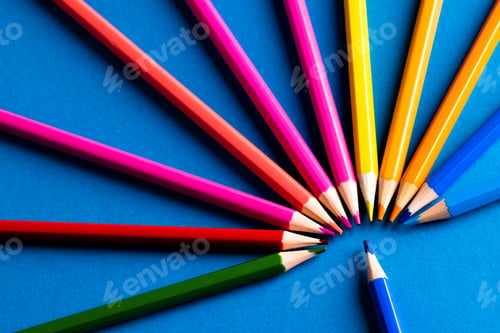 Preview: Close up of multi coloured pencils in circle and copy space on blue background