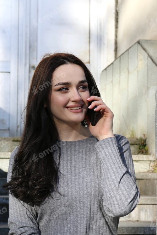 Preview: Smiling Woman Talking on Phone Outdoors