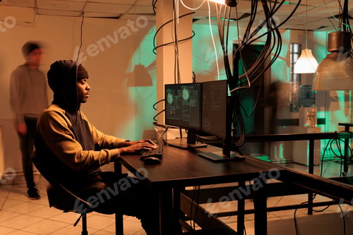Preview: African american hacker working on spyware with encryption