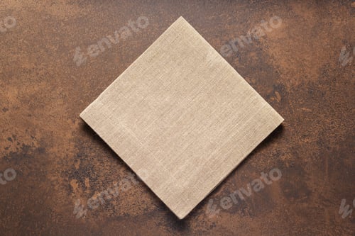 Preview: Folded burlap linen fabric tablecloth at stone surface of table