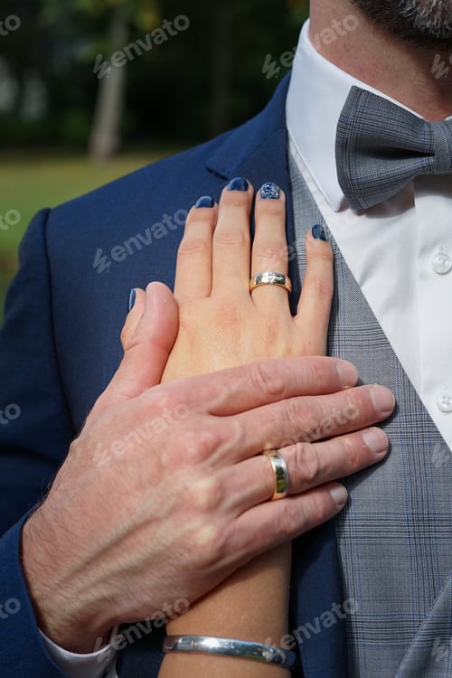 Loving Adult Couple Holding Hands Wearing Wedding Rings