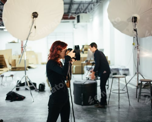 Preview: Photographer Taking Photos in Studio with Assistant
