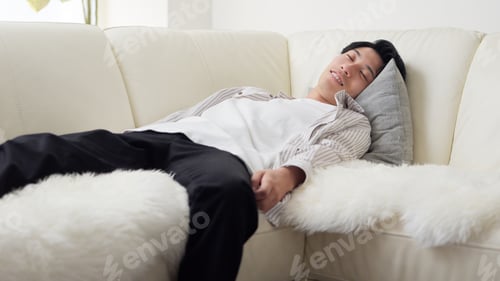 Preview: Asian man collapsed on the sofa