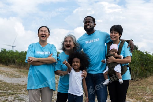 Preview: Family with daughter walking on field on wind farm.