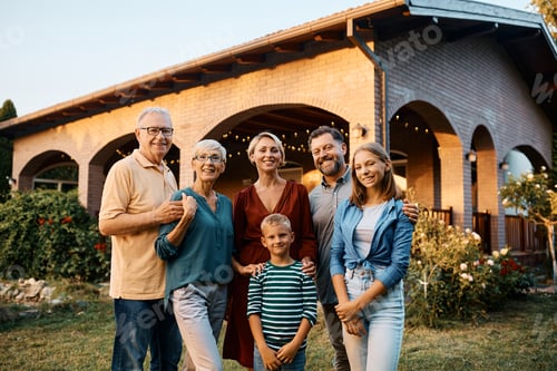 Preview: Happy multigeneration family in their backyard looking at camera.