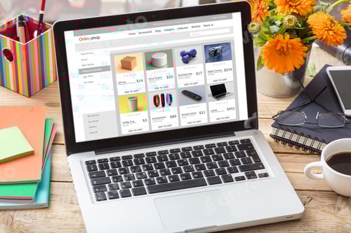 Preview: Online shop website design template on a laptop monitor, office desk background.