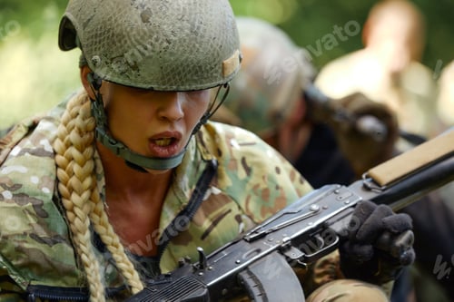 Preview: Caucasian Military lady woman in tactical gear posing for photo at summer season. Wearing green camo