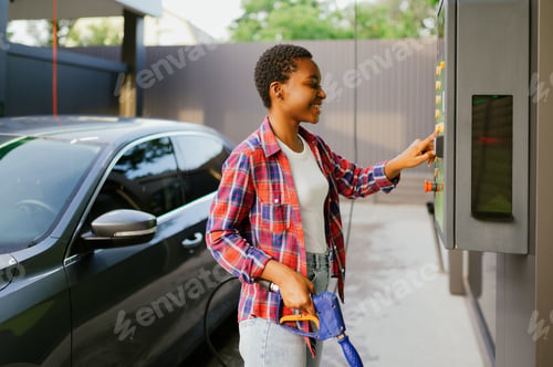 Preview: Woman choosing program on car wash station