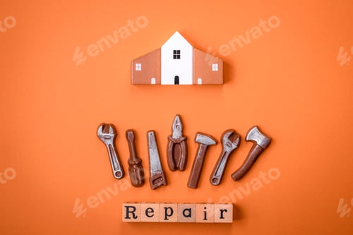 Preview: Repair or home improvement tools and a house model on a plain background