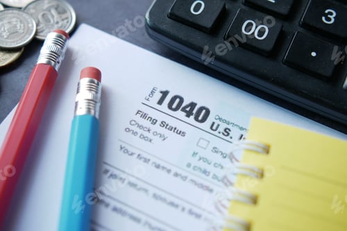 Preview: Close up of a Tax return form and pen on table.