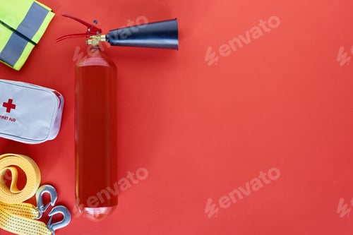 Preview: top view of fire extinguisher and automotive accessories on red backdrop