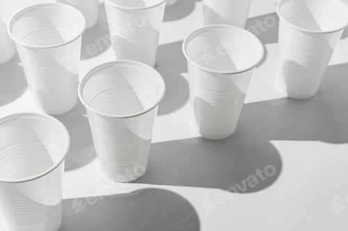 Preview: abstract pattern of plastic cups on color surface with harsh trendy shadows