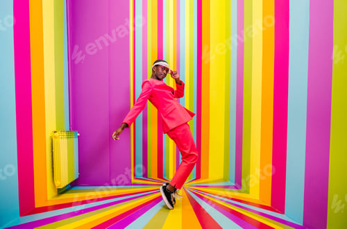 Preview: Beautiful young woman dancing and having fun inside a rainbow box room