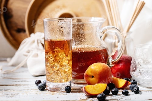 Preview: Cup of peach ice tea served with fresh peach