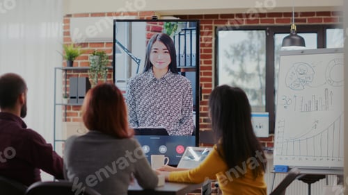 Preview: Diverse team attending online video call meeting with colleague