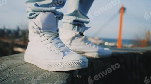Preview: White sneakers . Man in high top shoes outdoors