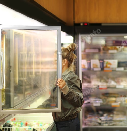 Preview: Woman Choosing Frozen Food From A Supermarket Freezer