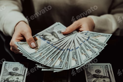 Preview: Woman counting US dollars. Pile of cash money background. Female person counts hundreds usd winning