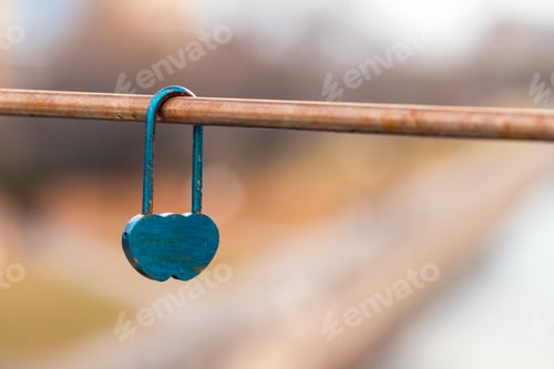 Preview: Heart shaped love lock hanging on bridge. Padlock as symbol love and fathfullness