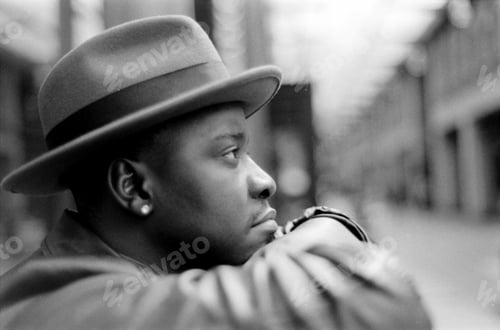 Preview: Stylish man wearing hat posing in black and white analog photo