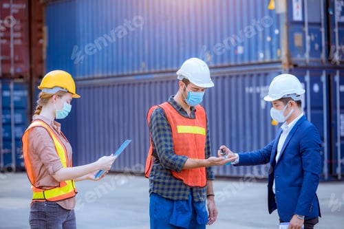 Preview: Engineer dock worker apply alcohol gel to clean hand for protect covid-19 virus spread to worker and