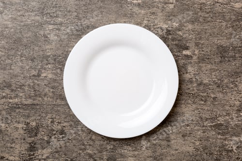 Preview: Top view of empty light plate on cement background. Empty space for your design