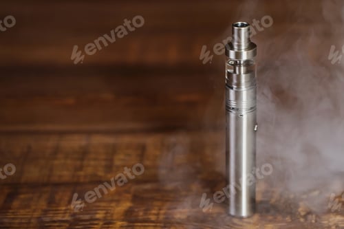 Preview: Electronic cigarette on a wooden table. Smoke.