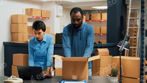 Preview: Business owners giving highfive after putting products in cardboard boxes
