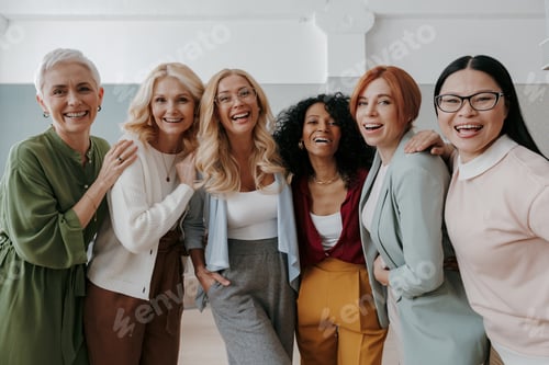 Preview: Multi-ethnic group of confident mature women embracing and smiling at camera