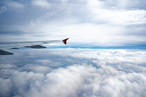 Preview: Aircraft wing above beautiful clouds and blue sky