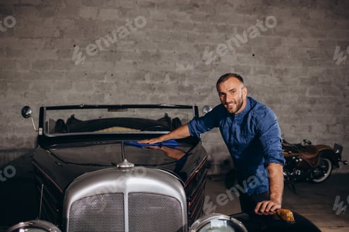 Preview: A man takes care of a retro car in the garage