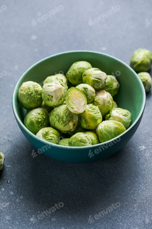 Preview: Raw Organic Brussel Sprouts in a Bowl, top view. Flat lay, overhead, from above. Copy space.