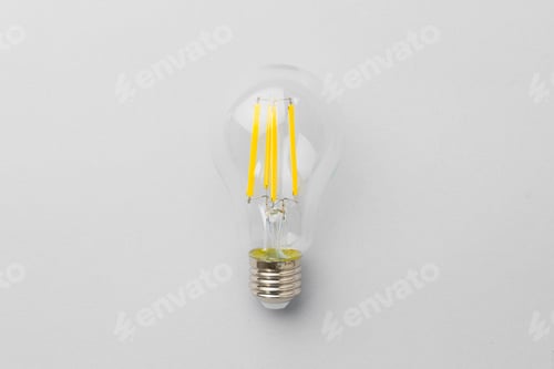 Preview: Light bulb on light grey paper background