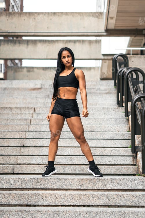 Preview: Young fitness woman posing outdoors