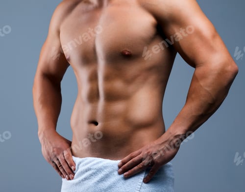 Preview: Cropped shot of an unrecognizable man posing in a towel against a grey background