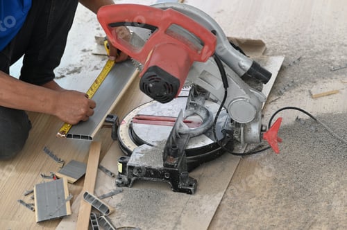 Preview: Closeup of a carpenter engaged in processing wood at the sawmill.