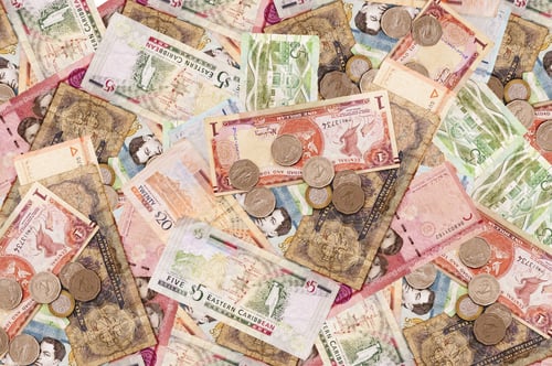 Preview: High angle shot of many banknotes and coins laid on the ground - corruption concept