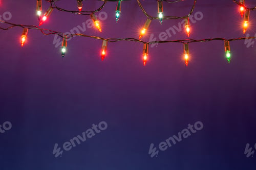 Preview: Christmas lights string on blue background with copy space