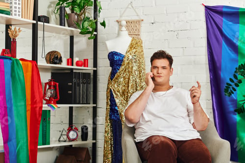 Preview: A unique queer individual engaged in a lively phone conversation in a colorful studio setting